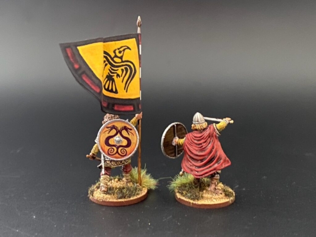 2 Viking commanders with banner from behind.
